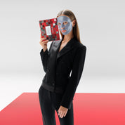 Model wearing a 111SKIN Cryo De-Puffing Facial Mask holding the Mask Discovery Collection box